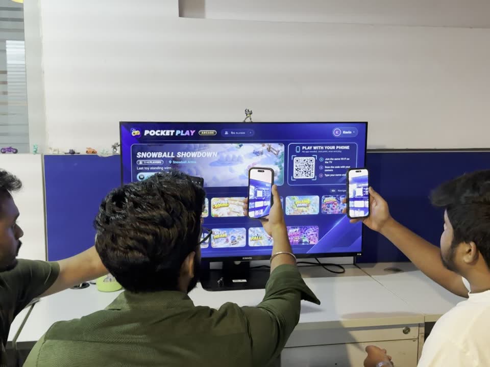 Three friends scanning the code on the TV with their phones